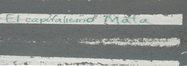 'El capitalismo Mata' sprayed on crosswalk